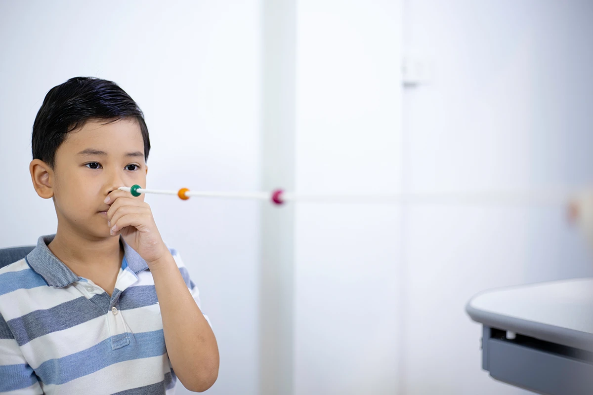 a boy using a brock string for vision therapy