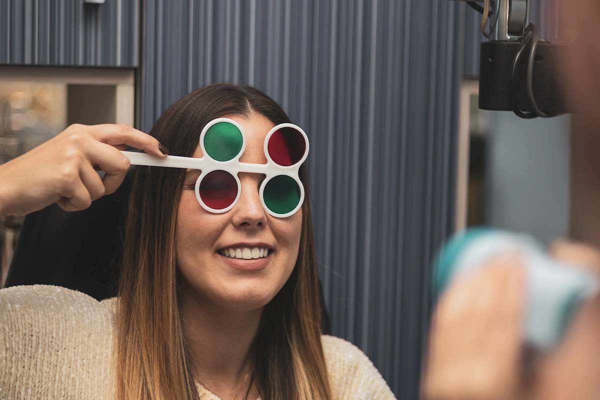 Person wearing red and green glasses at vision therapy